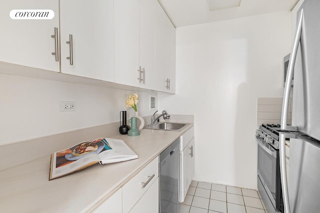 330 E 38th St Unit 27A, New York City, NY 10016 - kitchen featuring stainless steel appliances, light countertops, white cabinets, and light tile patterned floors