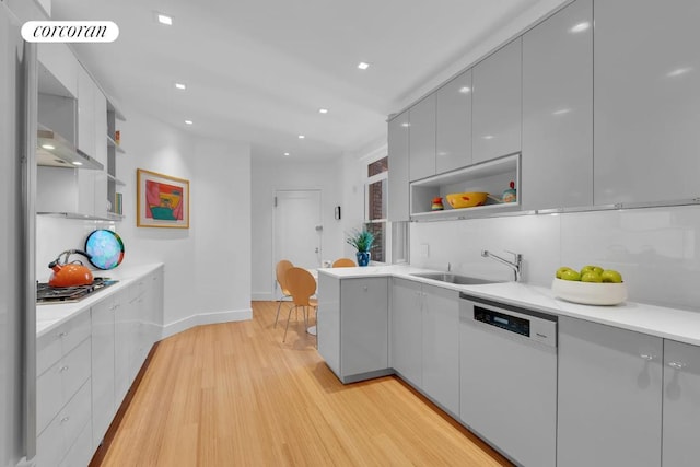 kitchen featuring sink, gray cabinetry, dishwasher, stainless steel gas stovetop, and light hardwood / wood-style floors