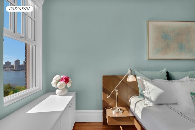 bedroom with wood finished floors and baseboards