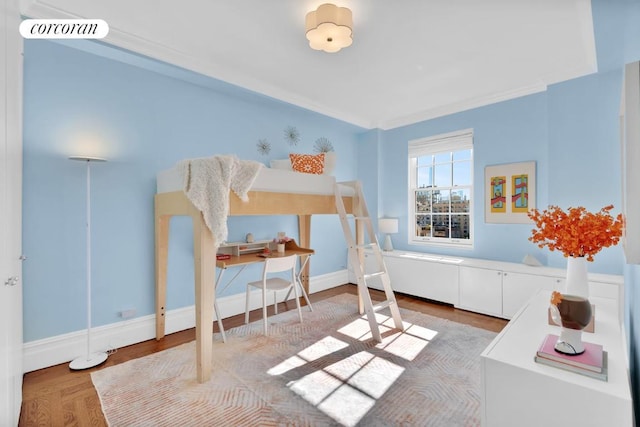 bedroom with crown molding and hardwood / wood-style flooring