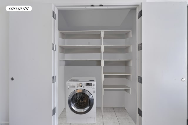 laundry room with washer / dryer and light tile patterned floors