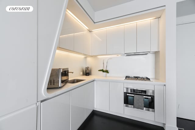 kitchen featuring stainless steel appliances and white cabinets