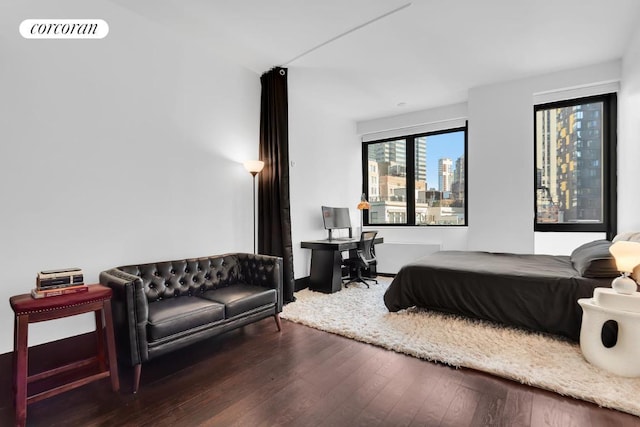 bedroom with dark hardwood / wood-style flooring