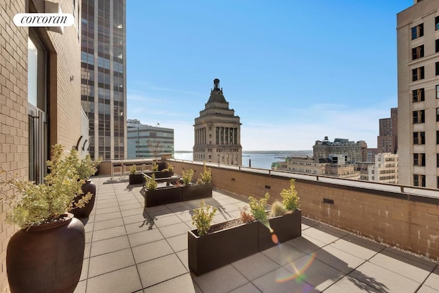 view of patio / terrace with a view of city and a water view