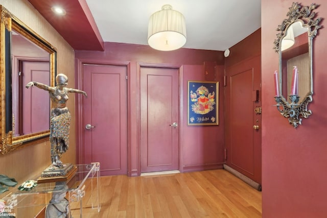 foyer entrance with light hardwood / wood-style floors