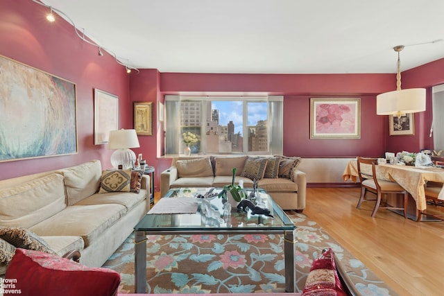 living area with a view of city and wood finished floors