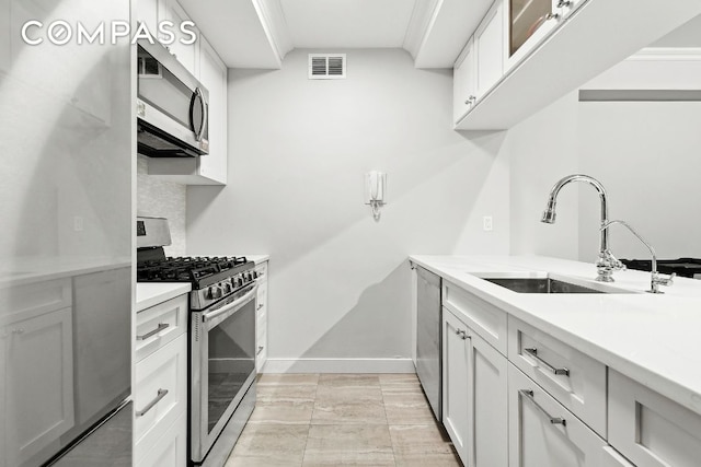 kitchen featuring sink, stainless steel appliances, and white cabinets