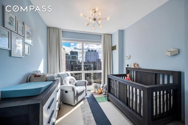 bedroom with visible vents, carpet floors, a city view, and an inviting chandelier