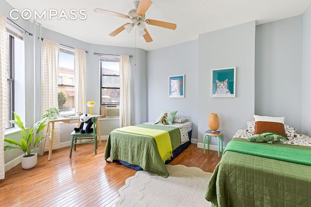 bedroom featuring cooling unit, ceiling fan, and wood-type flooring