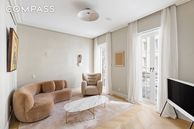 living room featuring crown molding, french doors, and baseboards