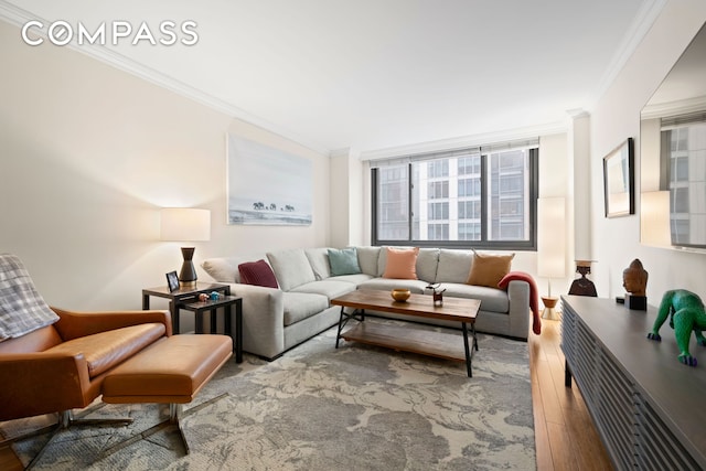 living area with ornamental molding and wood finished floors