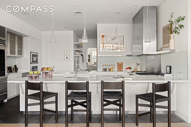 145 Hudson St Unit 7B, New York City, NY 10013 - kitchen featuring modern cabinets, light countertops, wall chimney exhaust hood, and recessed lighting