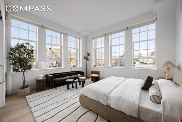 145 Hudson St Unit 7B, New York City, NY 10013 - bedroom featuring multiple windows, a view of city, and wood finished floors