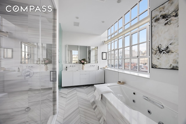 145 Hudson St Unit 7B, New York City, NY 10013 - full bathroom with double vanity, plenty of natural light, a whirlpool tub, and a shower stall