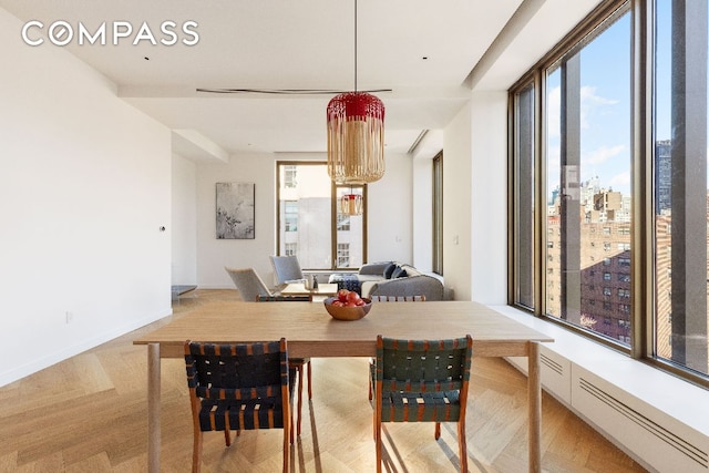 dining room with a view of city and baseboards