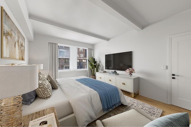 bedroom featuring beamed ceiling, crown molding, and hardwood / wood-style flooring