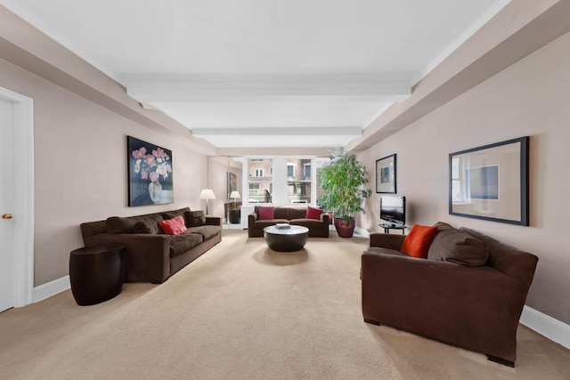 carpeted living room with beamed ceiling