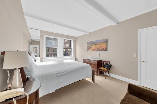 bedroom with beamed ceiling and light colored carpet