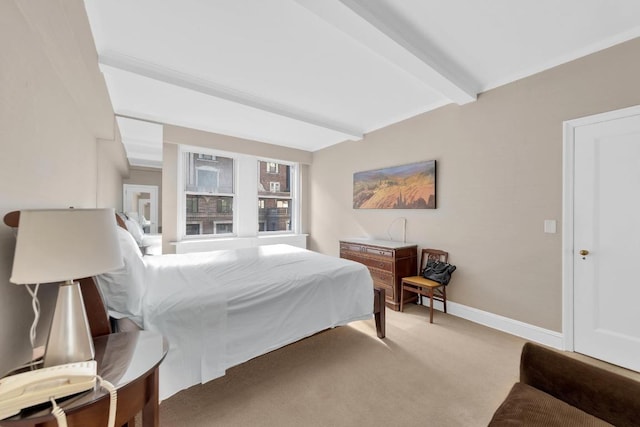 carpeted bedroom with beam ceiling