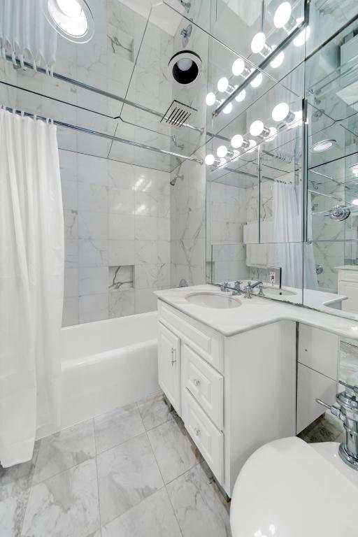 bathroom with shower / tub combo with curtain and vanity