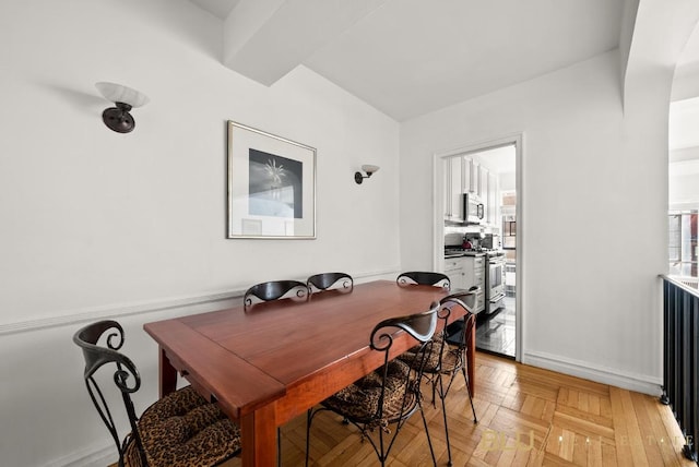 dining room featuring parquet floors