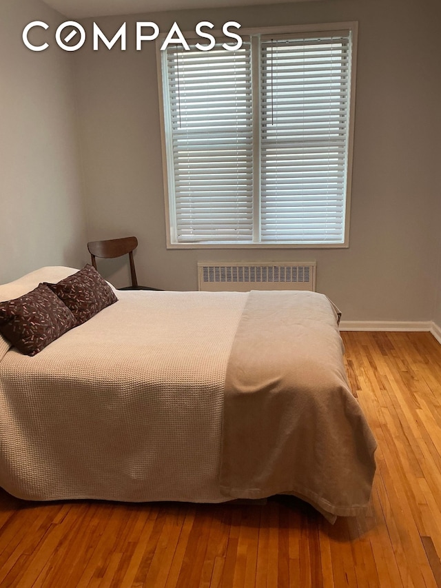 9801 Shore Rd Unit 2B, New York City, NY 11209 - bedroom featuring radiator heating unit and hardwood / wood-style floors