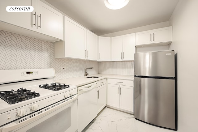 kitchen featuring marble finish floor, light countertops, decorative backsplash, a sink, and white appliances