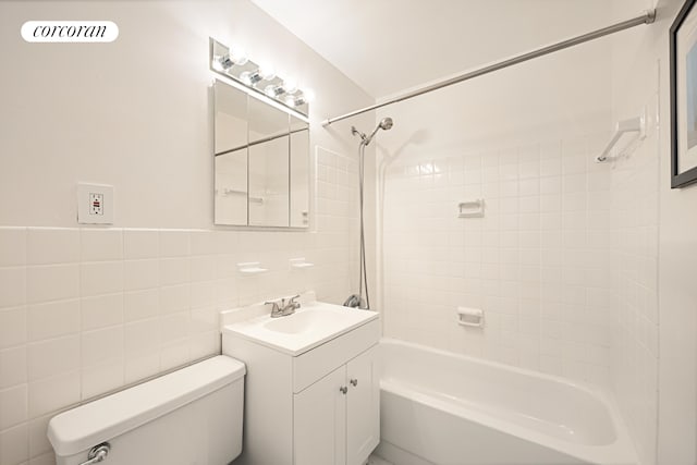 bathroom featuring bathtub / shower combination, tile walls, toilet, and vanity