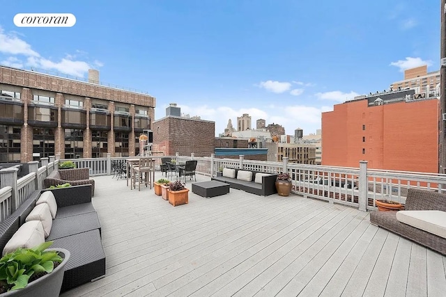 deck featuring an outdoor hangout area, outdoor dining space, and a city view