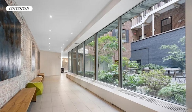 hallway with recessed lighting, a healthy amount of sunlight, and visible vents