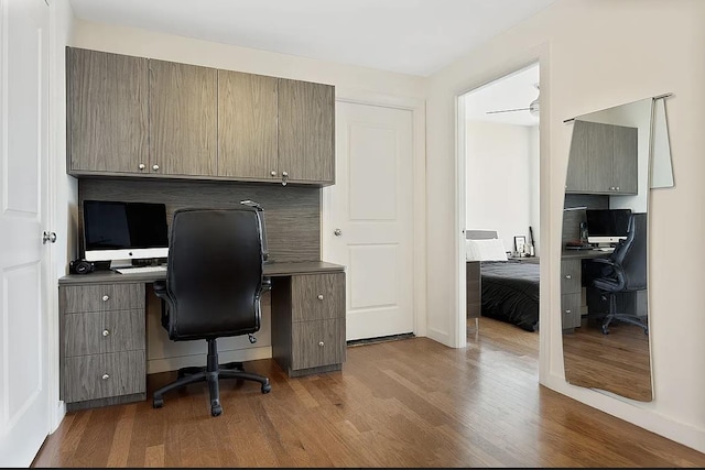 office area with dark wood finished floors and a ceiling fan