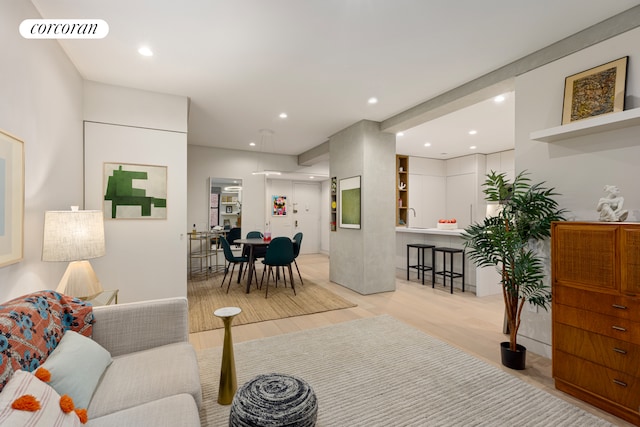 living area with recessed lighting, wood finished floors, and visible vents