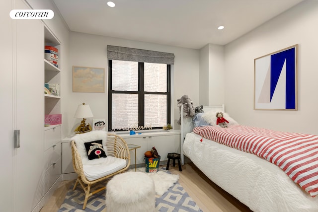 bedroom featuring recessed lighting and wood finished floors