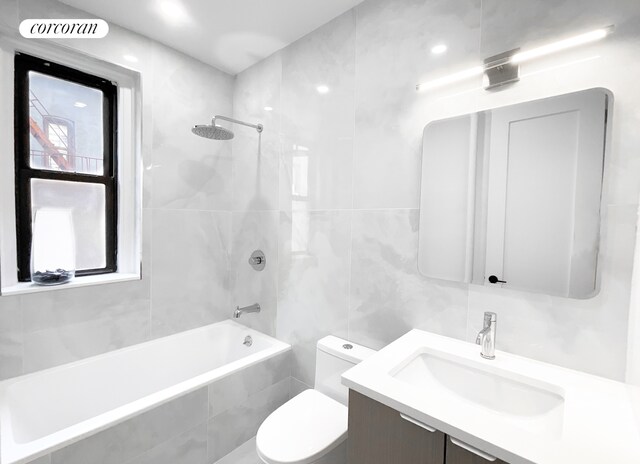 24-75 38th St Unit C2, New York City, NY 11103 - bathroom featuring vanity, tiled shower / bath combo, tile walls, and toilet