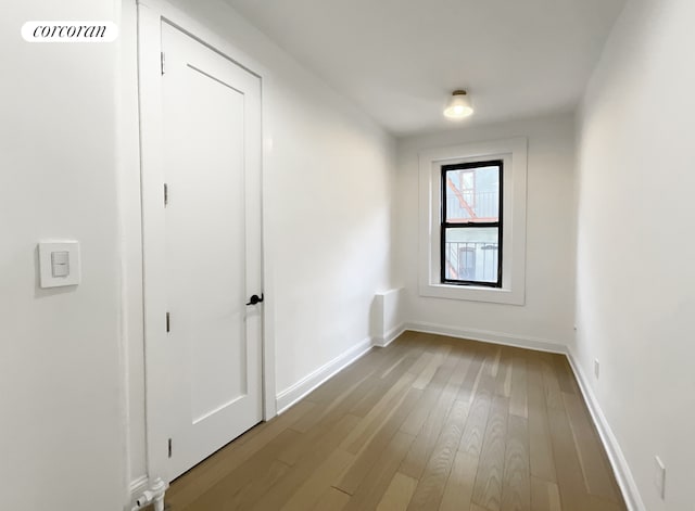 24-75 38th St Unit C2, New York City, NY 11103 - empty room with dark wood finished floors and baseboards