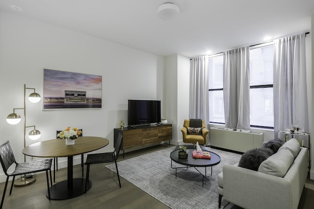 living area with baseboards and wood finished floors
