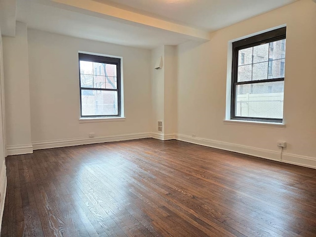 200 E 16th St Unit 2D, New York City, NY 10003 - spare room featuring dark wood-style flooring and baseboards