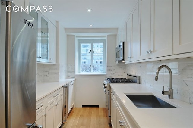 kitchen with sink, white cabinets, and appliances with stainless steel finishes