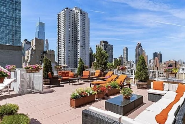 view of patio / terrace with a city view and an outdoor living space