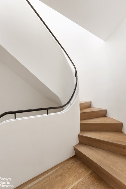 stairs featuring hardwood / wood-style flooring