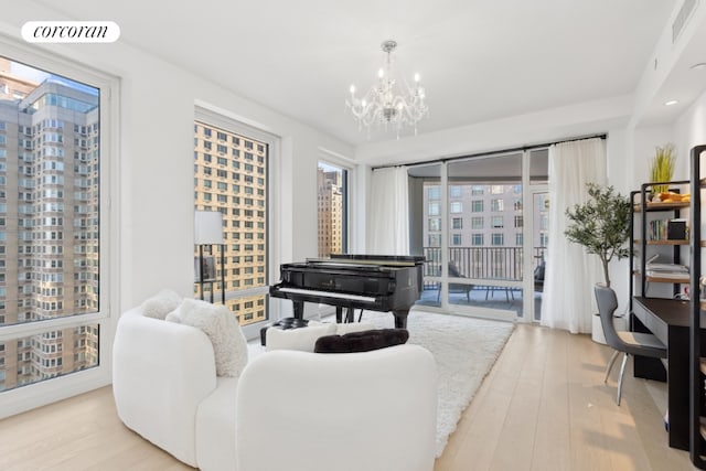 living room featuring an inviting chandelier and light hardwood / wood-style floors