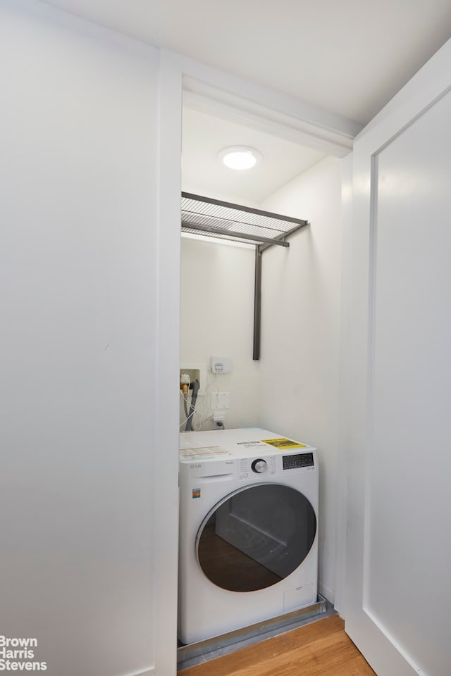 washroom with washer / dryer, light wood-style floors, and laundry area