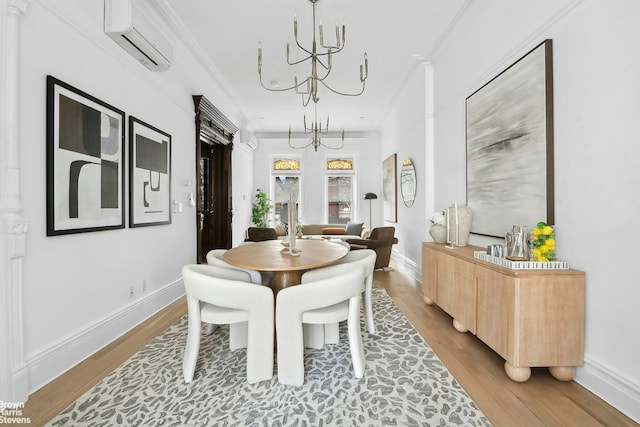 dining area with hardwood / wood-style floors, ornamental molding, an AC wall unit, and a chandelier