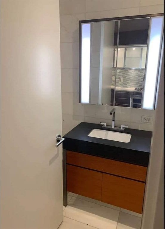 bathroom with tasteful backsplash, vanity, and tile patterned floors