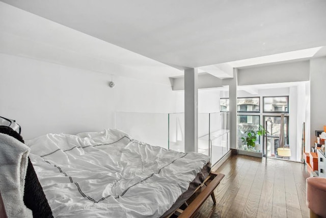 bedroom with dark wood-type flooring