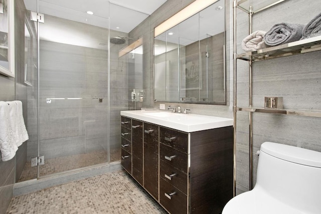 bathroom with toilet, a shower stall, and vanity