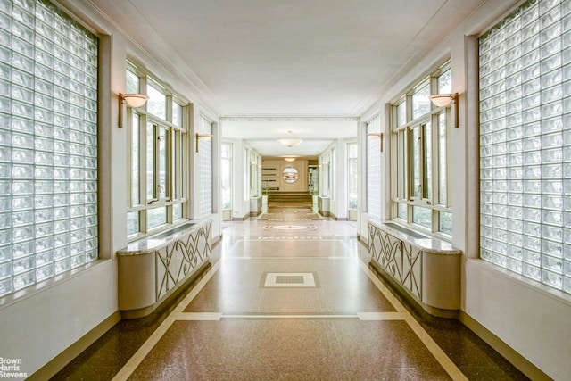 hall featuring baseboards and ornamental molding