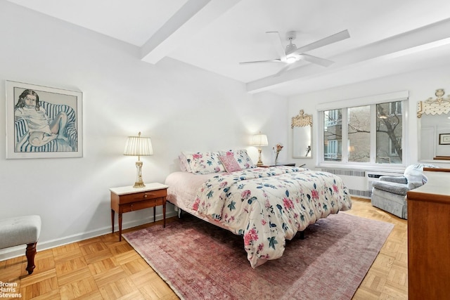 bedroom with beamed ceiling, ceiling fan, radiator, and light parquet floors