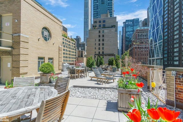 view of patio / terrace featuring outdoor dining area and a view of skyline