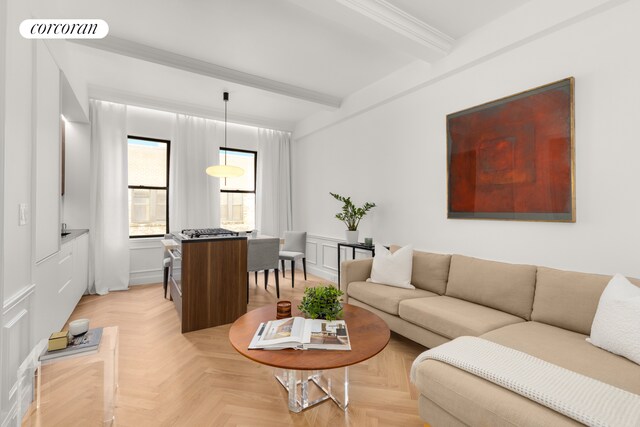 living room with beamed ceiling, light parquet flooring, and crown molding